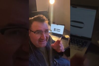 A man in a dim home office gestures toward a laptop displaying a product render, Hands-on Demo of karnkraft ar 2 Prototype on Home Office Laptop.