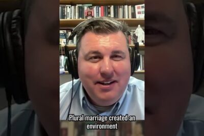 Man wearing headphones speaking in a podcast still with subtitle, relevant to kvinners stemmerett