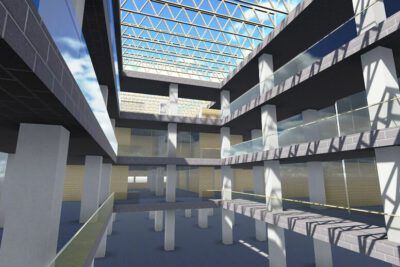 Interior of a sunlit multi-level atrium with glass skylight, columns and walkways highlighting la ciencia 1