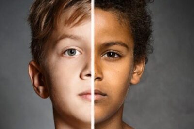 Split close-up portrait of two children with contrasting skin tones confronting la xenofobia