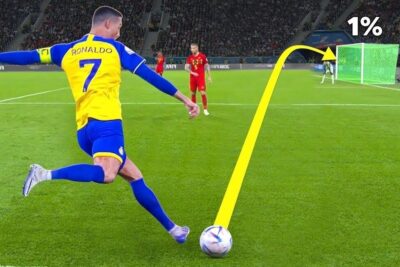 Yellow and blue kit player taking a powerful free kick in le football