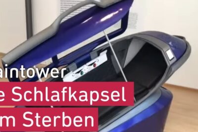 Purple sleeping capsule with open lid and padded interior showing a control panel, suggesting legalisierung euthanasie.