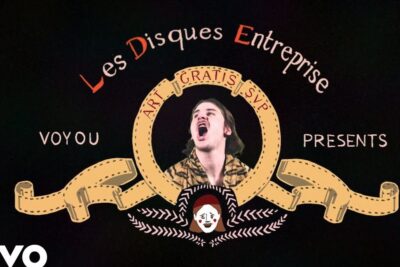 Stylized vintage music emblem with a central expressive portrait representing les humains.