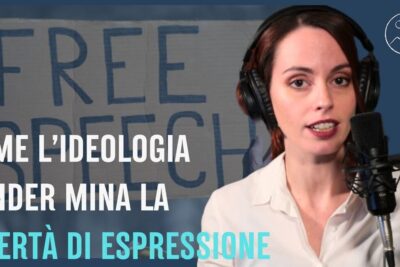 Woman wearing headphones speaking into a microphone in front of a 'FREE SPEECH' sign related to liberta espressione 2.
