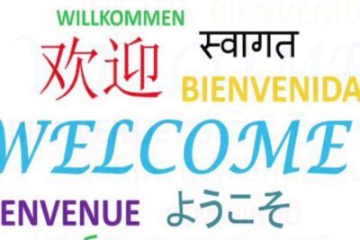 Colorful multilingual 'Welcome' graphic promoting lintegrazione sociale 1 and multicultural inclusion.