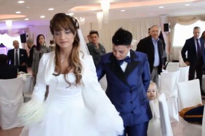 Bridal couple walking through a decorated reception venue after lunione civile.