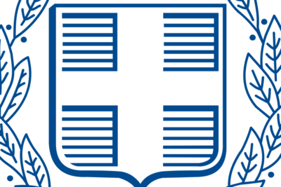 Blue laurel-wreathed shield emblem with four-panel cross and horizontal text lines, maahanmuutto voi.