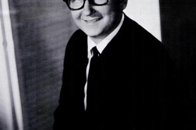 Smiling man in suit and glasses portrait reflecting machismo og