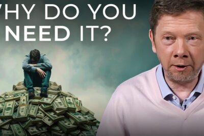 A contemplative man sitting on a pile of cash while a presenter discusses why you might need material possessions