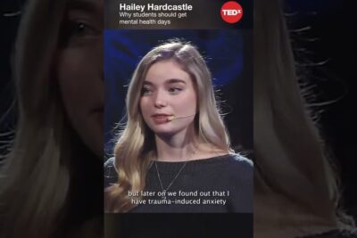 Young woman speaking on stage about mental health 1 and trauma-induced anxiety