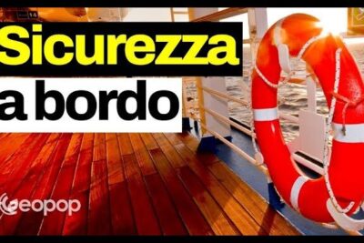 Red lifebuoy secured to a ship railing on a wooden deck at sunset highlighting misure sicurezza.