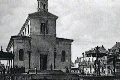Riverside stone church with steps, adjacent ornate buildings, fountain and small boats, monuments historiques 1
