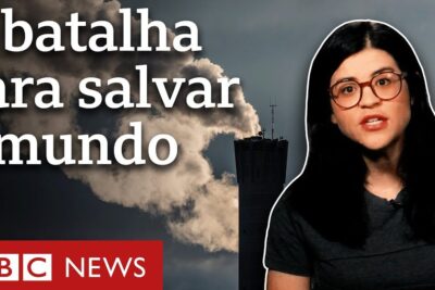 On-screen presenter with glasses beside a smokestack plume under dark clouds illustrating mudancas climaticas.