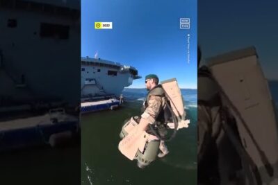 Uniformed operator using a jetpack for a maritime boarding maneuver to support national sikkerhed.