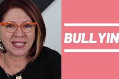 Middle-aged woman speaking beside bold pink graphic reading BULLYING, o bullying 1