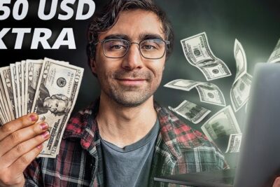 Smiling man holding a fan of US dollar bills and a laptop illustrating ways to obtener ingresos online