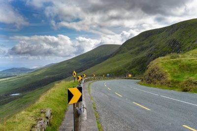 Winding mountain road along green cliffs suggesting a landscape of nationalism.