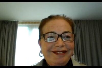 Smiling woman in glasses during a virtual meeting representing offentlige tjenester 3.