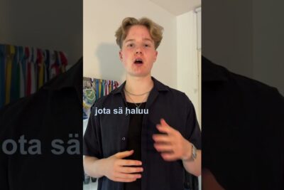 Young man speaking to camera in a vertical social video with overlay text and background pennants on tarkeaa 96