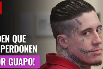 Tattooed man in a red court jumpsuit glancing sideways with prominent facial tattoos, pena muerte 17