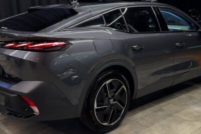 Rear three-quarter view of a sleek grey peugeot 408 12 with LED taillights and alloy wheel.