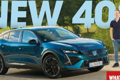 Teal metallic Peugeot 408 8 fastback crossover parked outdoors with a person standing nearby.