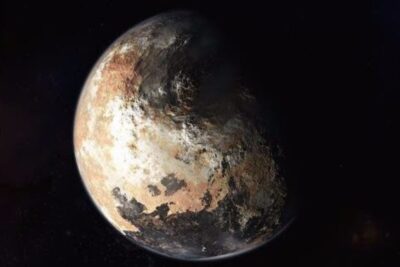 Close-up view of pluto planet 6 showing textured icy surface and a shadowed hemisphere
