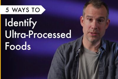 Male speaker beside bold overlay text about five ways to identify processed foods on a purple background