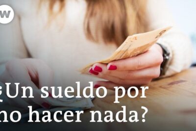 Renta basica 1: Woman counting cash questions universal basic income debate, close-up of hands sorting euro banknotes on a wooden table.