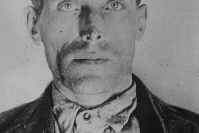 Archival identification-style monochrome portrait of a solemn man suitable for retfardig rettergang topics.