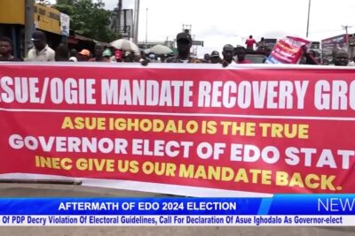 Protesters hold a large red banner demanding revocering mandat and return of the governor-elect mandate.