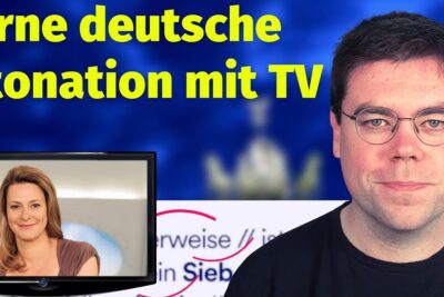 Presenter with glasses beside a TV screen illustrating a German lesson about sie betonen