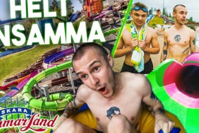 Three men enjoying a bright green and pink tube slide at skara kottet waterpark