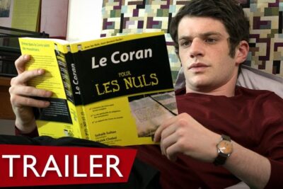 Man reclining and reading a yellow 'Le Coran' paperback in a calm interior, suggesting themes like sostengono burka