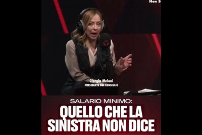 Woman in broadcast studio wearing headphones and speaking into a microphone about stipendio minimo 1 and minimum salary