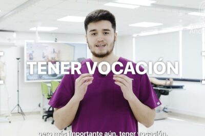 Young person in purple medical scrubs speaking in a bright simulation lab demonstrating tecnologias medicas 1.