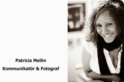 Black-and-white portrait of a smiling communicator and photographer reflecting traditionelle medier sensibilities.
