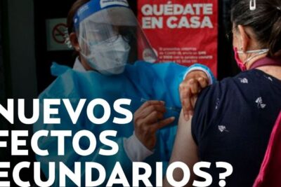 Healthcare worker administering vacinas covid 19 in protective gear at community clinic to a masked patient receiving an injection