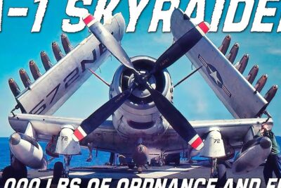 A-1 Skyraider with folded wings, heavy underwing ordnance and propeller on a carrier deck vaittavat etta 9