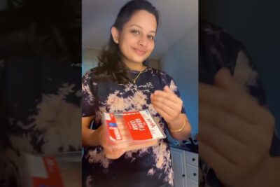 Person in a home kitchen holding a packaged vegetarian product labeled vare vegetar 1