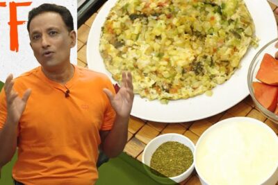 Man in orange shirt presenting a vare vegetar vegetable frittata with bowls of chopped tomatoes, green seasoning and creamy sauce