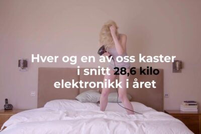 Person standing on a bed using a hairdryer, illustrating household electronics as a verdifull ressurs.