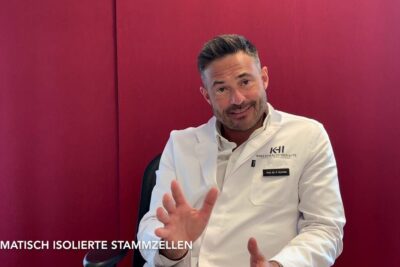 Medical professional in a white lab coat gesturing while discussing verwendung stammzellen