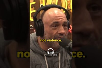 Bald man wearing headphones speaking into a microphone with yellow on-screen text 'not violence.' voldelige argumenter 1