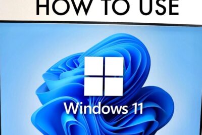 Monitor displaying the Windows 11 logo and blue wallpaper with a visible 'How to Use' header, ideal for windows 11 10 tutorials.