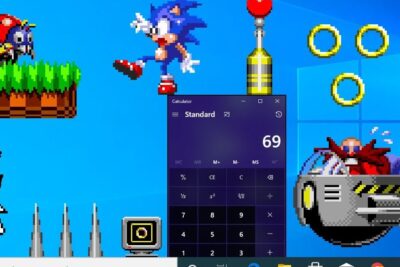 Retro pixel desktop with Sonic, Eggman, golden rings and a Calculator window showing 69 for windows sonic 6