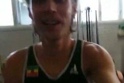 Blurred gym selfie of an individual in a tank top during a workout featuring xenonin kaytto.
